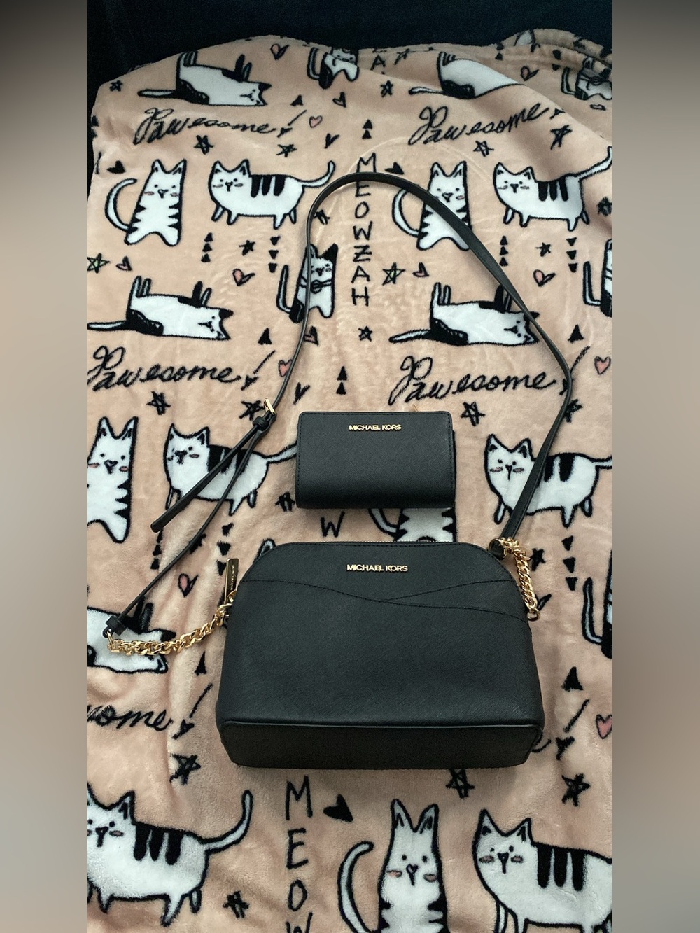 Michael Kors black crossbody and wallet with gold hardware.